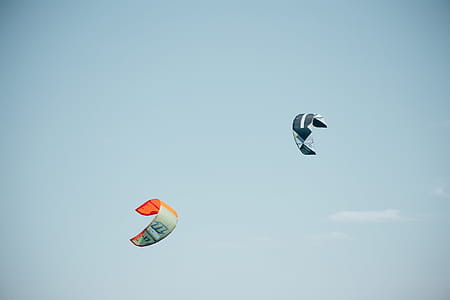 Colorful surfing kites flying high in the sky thumbnail