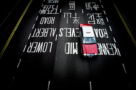 aerial photography of maroon and white vehicle on black road thumbnail