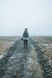 man walking on gray sand thumbnail