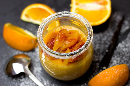 orange marmalade in jar beside spoon thumbnail