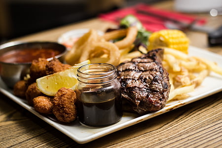 steak and sliced lemon in white ceramic plate thumbnail