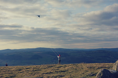 person playing with kite thumbnail