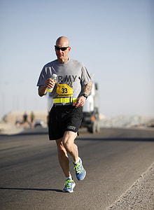 man jogging beside road thumbnail