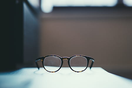black framed eyeglasses on white surface thumbnail