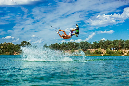 man parasailing on body of water thumbnail