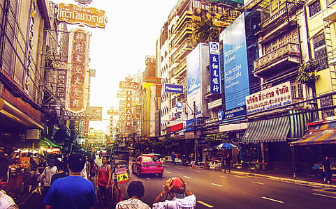 people and vehicles on street during daytime thumbnail
