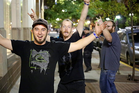 group of men taking photo on street thumbnail