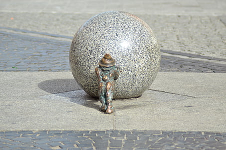concrete ball with man pulling art work outdoors thumbnail