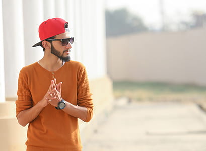 selective focus photography of man standing near white pillars thumbnail