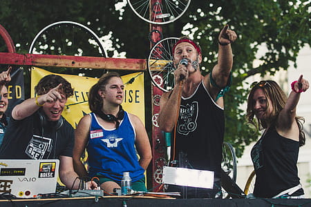 Man Wearing Black Tank Top Holding Microphone While Pointing thumbnail