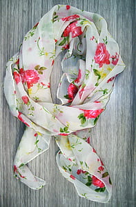 white and red floral wreath mounted on table thumbnail