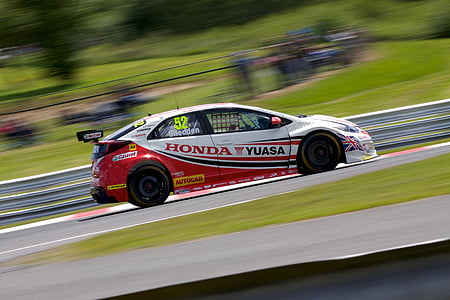 white Honda car running on race track thumbnail