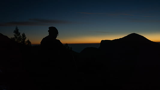 silhouette of person standing in top of a hill thumbnail
