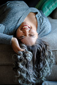 woman lying on gray sofa thumbnail