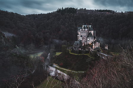 white and grey castle between landscape mountain thumbnail