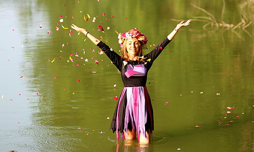 standing woman on water raising her arm upwards thumbnail
