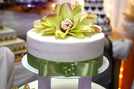 selective focus photography of icing cake top with yellow petaled flower on tray thumbnail