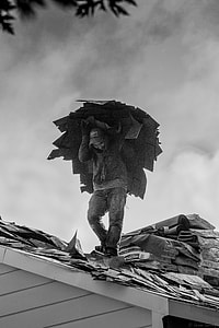 person carrying roof rugs on top of house thumbnail