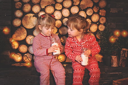two girls wearing footie pajamas sipping drink thumbnail
