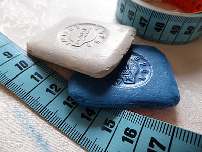 two white and blue stones near measuring tape thumbnail