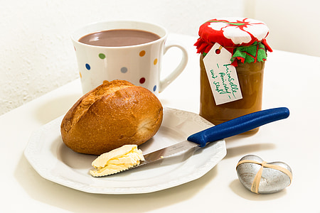 baked bread beside butter on knife on plate thumbnail