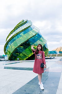 Woman in Front of Green Glass Building thumbnail