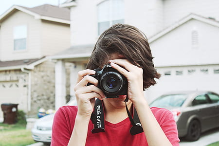 woman holding Canon DSLR camera thumbnail