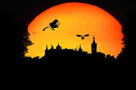 silhouette of witch and castle during sunset thumbnail