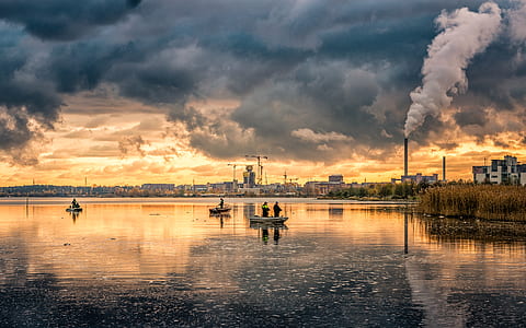 two person in boat under cloudy sky thumbnail