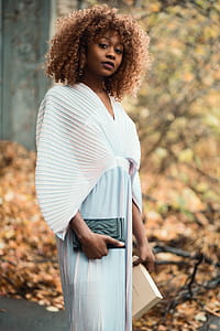 Photo of Woman Wearing White Dress and Holding Black Purse thumbnail