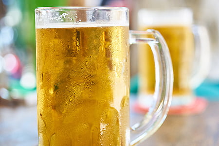 clear glass mug filled with beer thumbnail