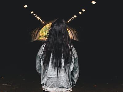 woman wearing jacket standing in tunnel thumbnail
