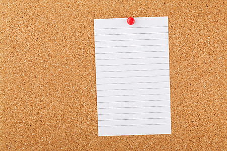 white page of notepad and brown cork board thumbnail