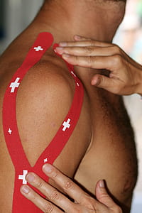 man with red strap on shoulder thumbnail