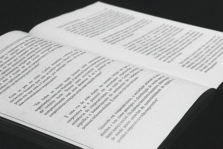 opened white book on black surface thumbnail