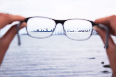 tilt shift lens of eyeglasses staring at ship thumbnail