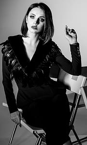 woman wearing black v-neck feather-neckline long-sleeved dress in greyscale photo thumbnail