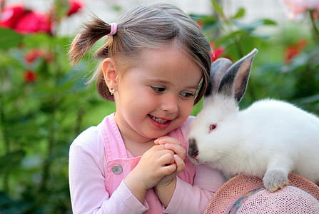 photo of girl in pink top beside white rabbit thumbnail