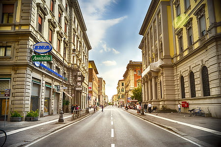 asphalt road in between buildings during daytime thumbnail