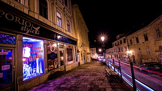 street lights near road and buildings at night time thumbnail