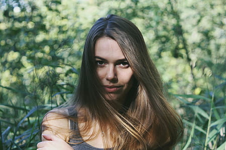 woman in black tank top near green leafed plants thumbnail