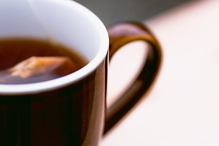 selective focus photography of brown mug filled with tea thumbnail