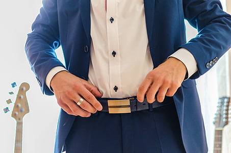 man wearing blue blazer near guitars at daytime thumbnail