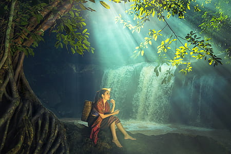 female under tree near water falls thumbnail