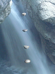 gray pebble stone with rope between rock fomation thumbnail