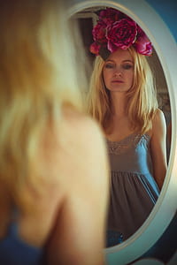 woman looking herself in front of mirror thumbnail