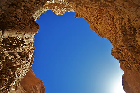 beige rock formation under blue sky during day thumbnail