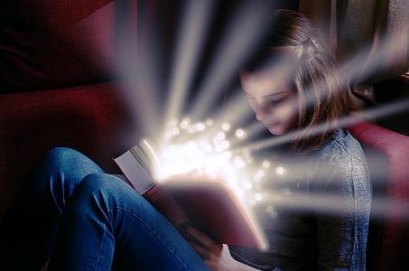 woman wearing gray crew-neck shirt reading book photo thumbnail