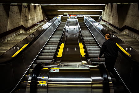person standing on a escalator thumbnail