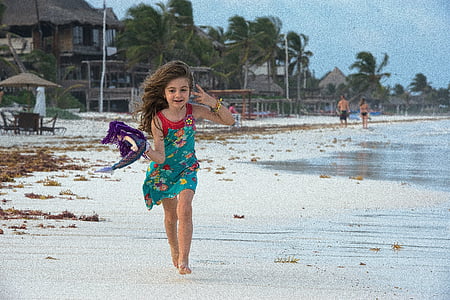 panning photography of girl holding purple textile running on seashore thumbnail